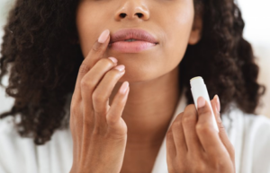 Close up of woman applying lip balm
