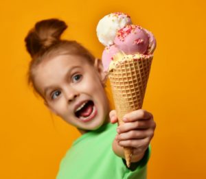 a girl holding icecream