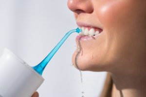 a woman cleaning her teeth