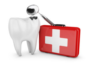 First aid of a teeth decayed tooth, a dental mirror and a red suitcase with white cross