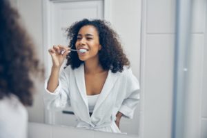 a woman brushing dirty teeth