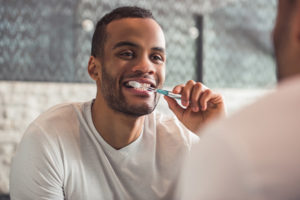 a man brushing his teeth