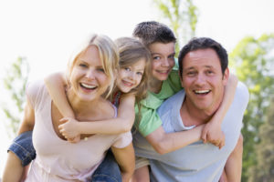 couple with kids smiling