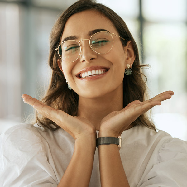 woman with glasses smiling