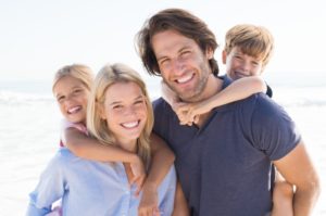 couple with kids smiling